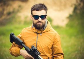uma homem com a automático rifle foto
