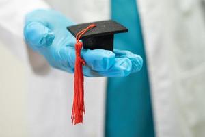 estudo de médico asiático aprende com chapéu de graduação na enfermaria do hospital, conceito de medicina de educação de gênio brilhante inteligente. foto