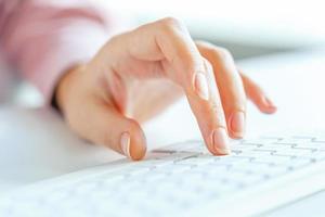 mulher escritório trabalhador digitando em a teclado foto