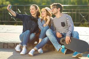 sorridente amigos fazer selfie ao ar livre foto