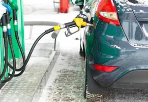 carro reabastecimento em uma gasolina estação dentro inverno foto