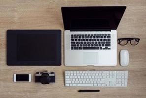 o negócio local de trabalho com computador portátil e aparelhos em de madeira fundo foto