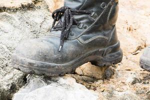 bota de couro trekking na rocha foto