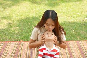 mãe e bebê jogando dentro a parque Felizmente. foto