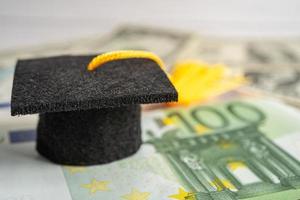 chapéu de lacuna de graduação em dinheiro de notas de euro e dólar americano, taxa de estudo de educação aprendizagem ensinar conceito. foto