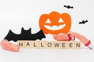 adereços de festa de halloween com blocos de madeira com o texto halloween em um fundo branco foto