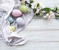 bolsa de barbante com ovos de páscoa e flor de primavera foto