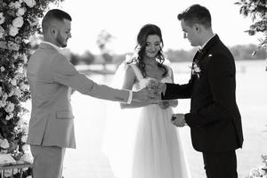 cerimônia de casamento em um píer alto perto do rio foto