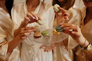 menina segurando colorida francês macarons dentro mãos foto