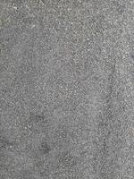 textura de terra de rochas pequenas cinza. fundo de pedra preta pequena estrada. cascalho seixos pedra textura perfeita. fundo escuro de cascalho de granito triturado, close-up. argila aglomerada foto
