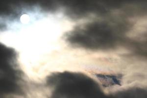 Sol disco atrás retroiluminado nuvens foto