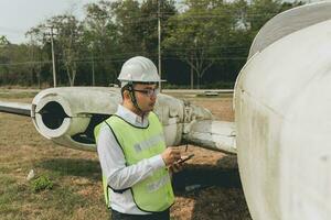 engenheiro mantendo uma helicóptero motor. masculino motor mecânico helicóptero verificação helicóptero antes levar fora foto