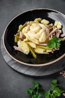 salada pepino, batata, salsicha, maionese pronto para comer refeição Comida lanche em a mesa cópia de espaço Comida fundo rústico topo Visão foto