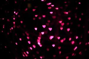 desfoque rosa vermelho corações cinza forma bokeh luz de fundo foto