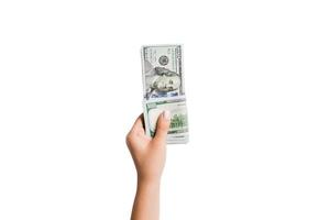 fêmea mão dando dinheiro em branco isolado fundo. topo Visão do dólar notas. suborno conceito. dívida e empréstimo conceito foto