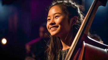 jovem ásia menina jogando dela violoncelo às a show corredor debaixo dramático luzes - geração ai. foto