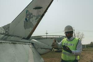 aeronave mecânico examinando avião asa foto