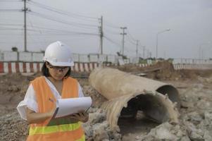 Civil engenheiros trabalhando às uma construção local, o companhia Gerente supervisiona a estrada construção. foto