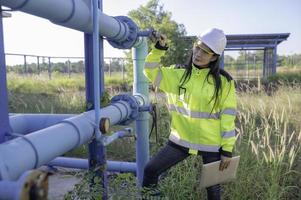 engenheiros ambientais trabalham em estações de tratamento de águas residuais, técnico de encanador feminino trabalhando no abastecimento de água foto