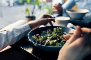 fresco salada dentro uma prato delicioso Comida dieta garfo dentro mão fêmea mãos cafeteria foto