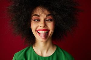 retrato do uma encantador senhora afro Penteado verde vestir emoções fechar-se vermelho fundo inalterado foto