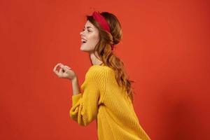 alegre mulher dentro amarelo suéter vermelho arco de cabelo decoração moda rua estilo foto