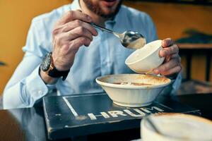 homem comendo borscht e Arroz a grega cafeteria restaurante interior o negócio finança camisa modelo foto