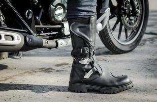 bota de motociclista com motocicleta foto