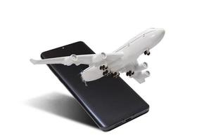 avião moscas Fora do a Smartphone monitor em uma branco fundo foto