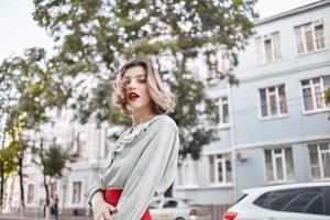 bonita mulher ao ar livre vermelho lábios andar estilo de vida posando foto