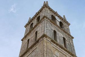 pedra torre com católico Igreja campanário foto