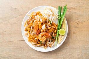 frutos do mar pad thai - misture macarrão frito com camarão, lula ou polvo e tofu foto