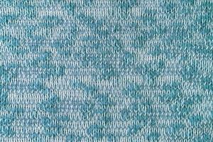 brilhante turquesa branco mistura malhas lã tecido textura fundo. abstrato têxtil pano de fundo foto