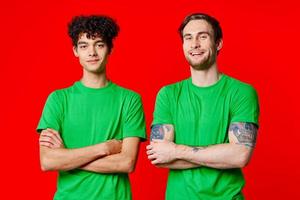 dois homens dentro verde Camisetas ficar de pé Próximo para comunicação amizade foto