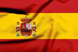 Espanha bandeira em a texturizado pano, contemporâneo vermelho e amarelo bandeira conceito com uma torção foto
