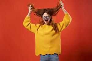 alegre atraente mulher segurando cabelo óculos moda estúdio foto