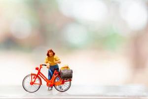 miniatura ciclista em pé com bicicleta, mundo bicicleta dia conceito foto