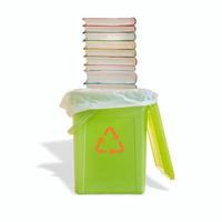 verde lixo Lixo bin com saco e uma pilha do livro de bolso livros com Está sombra e reciclando símbolo em a bin isolado às branco fundo. conceito do papel reciclando. foto