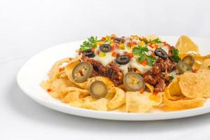 mexicano famoso Comida picante terra carne nachos. aquecido crocante tortilla salgadinhos com derretido queijo e Pimenta jalapeno servido uma lanche Comida. foto