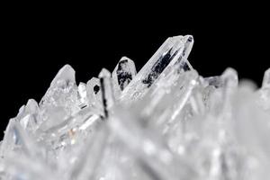 strass de pedra mineral macro em cristais em um fundo preto foto