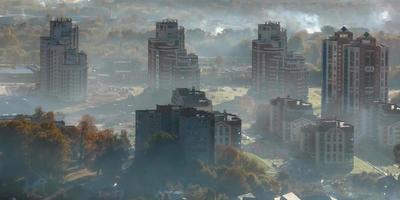 vista aérea da cidade verde com arranha-céus e edifícios residenciais em ganhar neblina e neblina foto