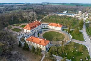 aéreo Visão em negligenciar restauração do a histórico castelo ou Palácio perto lago foto