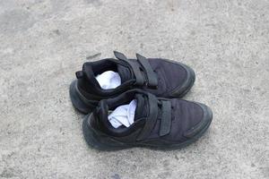 foto do Preto sapatos desgastado em a rua