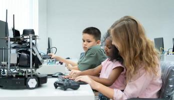 jovens utilizando a mão robô tecnologia estão tendo Diversão Aprendendo a eletrônico o circuito borda e mão robô controlador do robô tecnologia, que é 1 do a haste cursos. foto