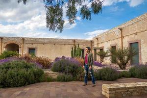 homem visitando a velho rústico modelo escola com cacto dentro mineral de pozos guanajuato México foto