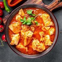 frango carne tomate molho, vegetal refeição Comida lanche em a mesa cópia de espaço Comida fundo rústico topo Visão foto