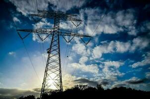 uma campo com eletricidade postes foto