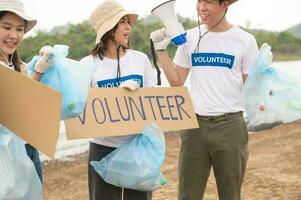 voluntários a partir de a ásia juventude comunidade usando lixo bolsas limpeza acima natureza par foto