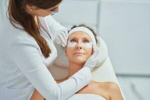 mulher tendo cosmetologia sobrancelhas tratamento dentro beleza salão foto