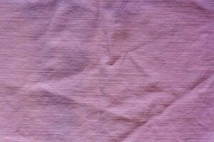 a textura do a tecido é Rosa. horizontal pontos. a tecido é enrugado. foto